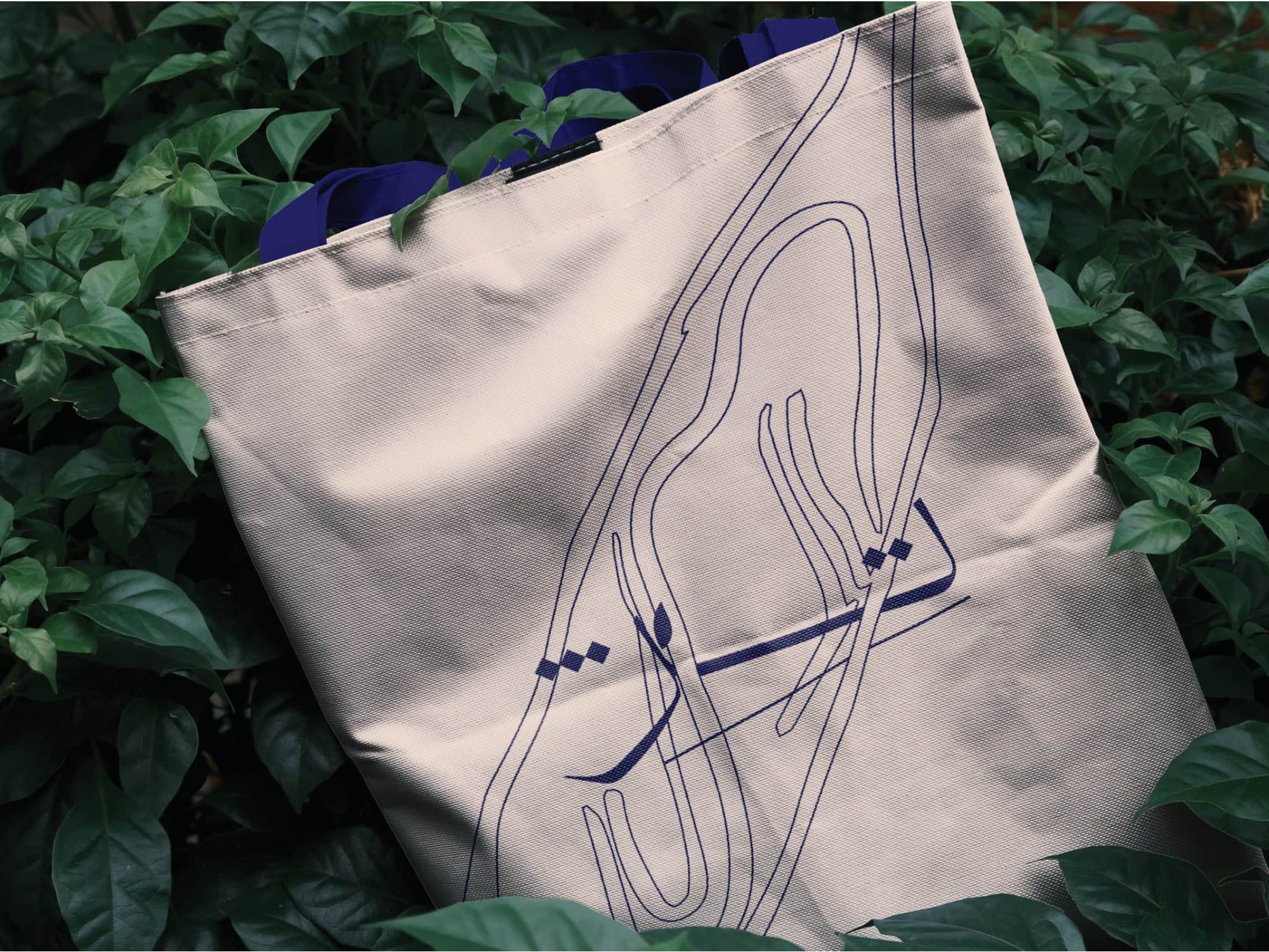 Printed tote bag among foliage